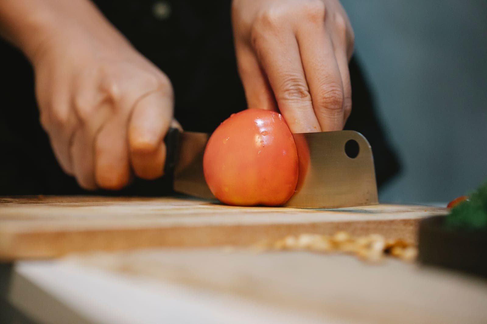 A kitchen knife resting on a wooden cutting board