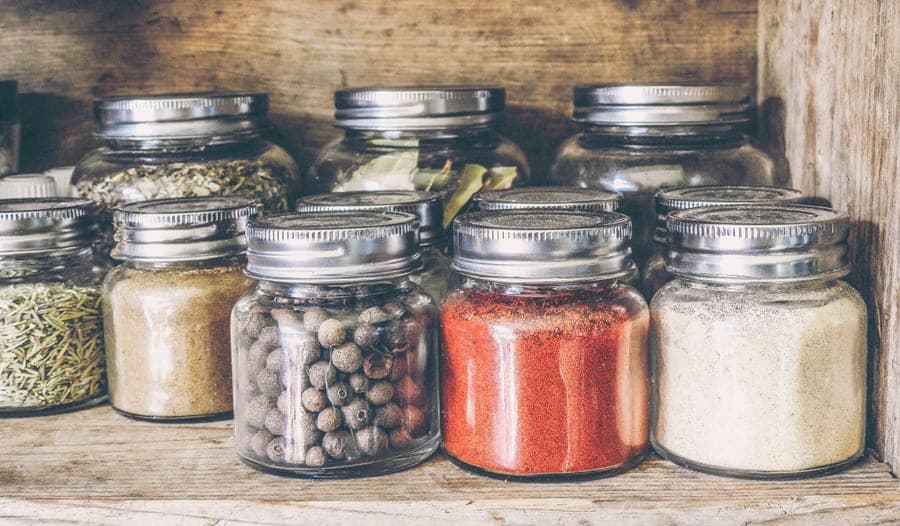 Jars of dried herbs and whole spices