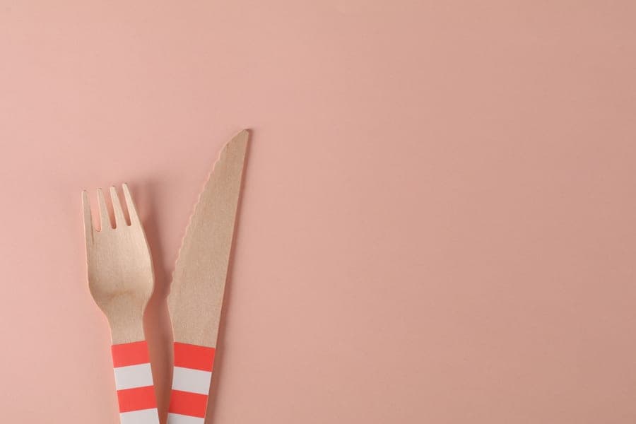 A carving knife and fork laid on a cloth