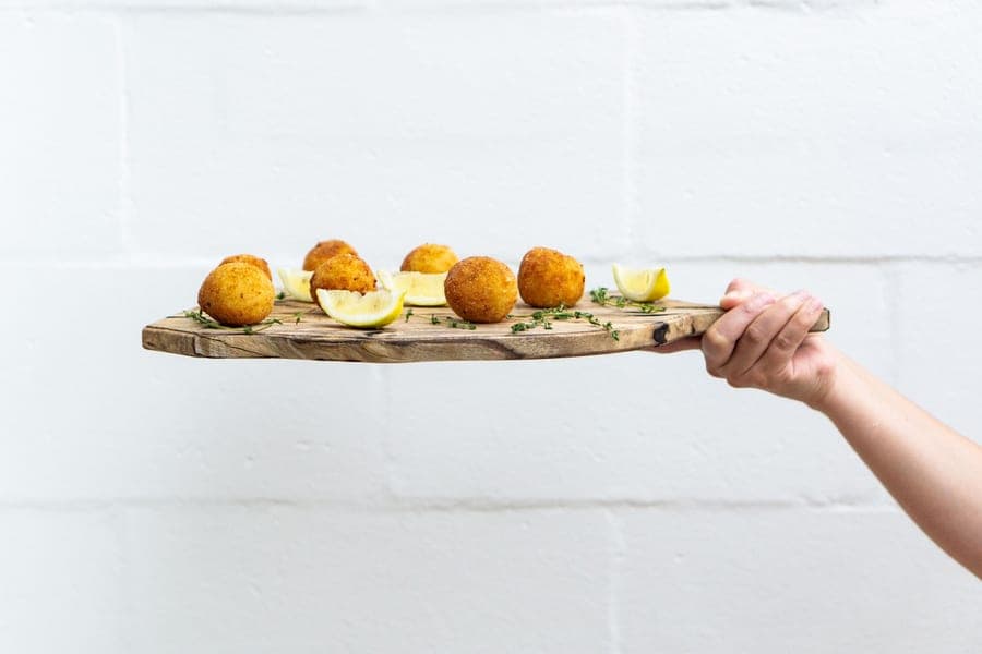 A wooden serving board with a handle