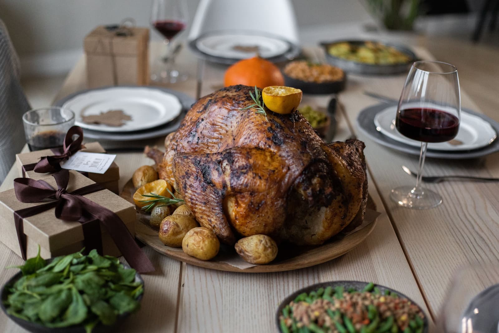 A holiday table laid with plates, glasses and serving dishes