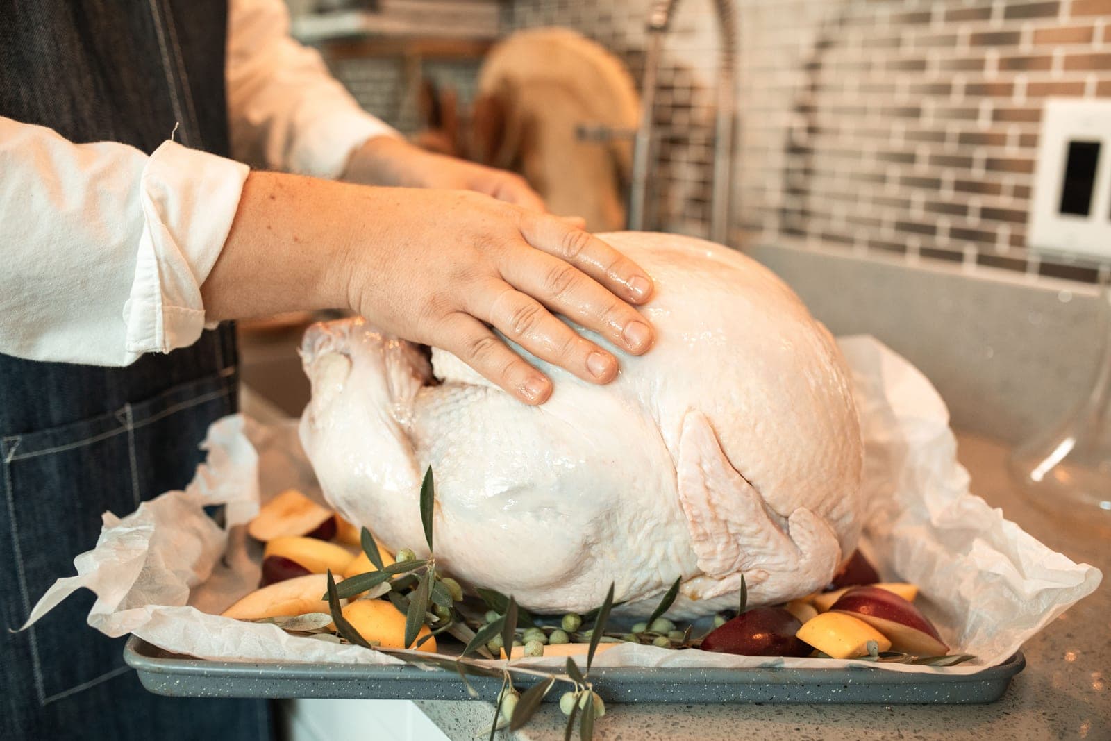 A raw turkey on a kitchen counter before cooking